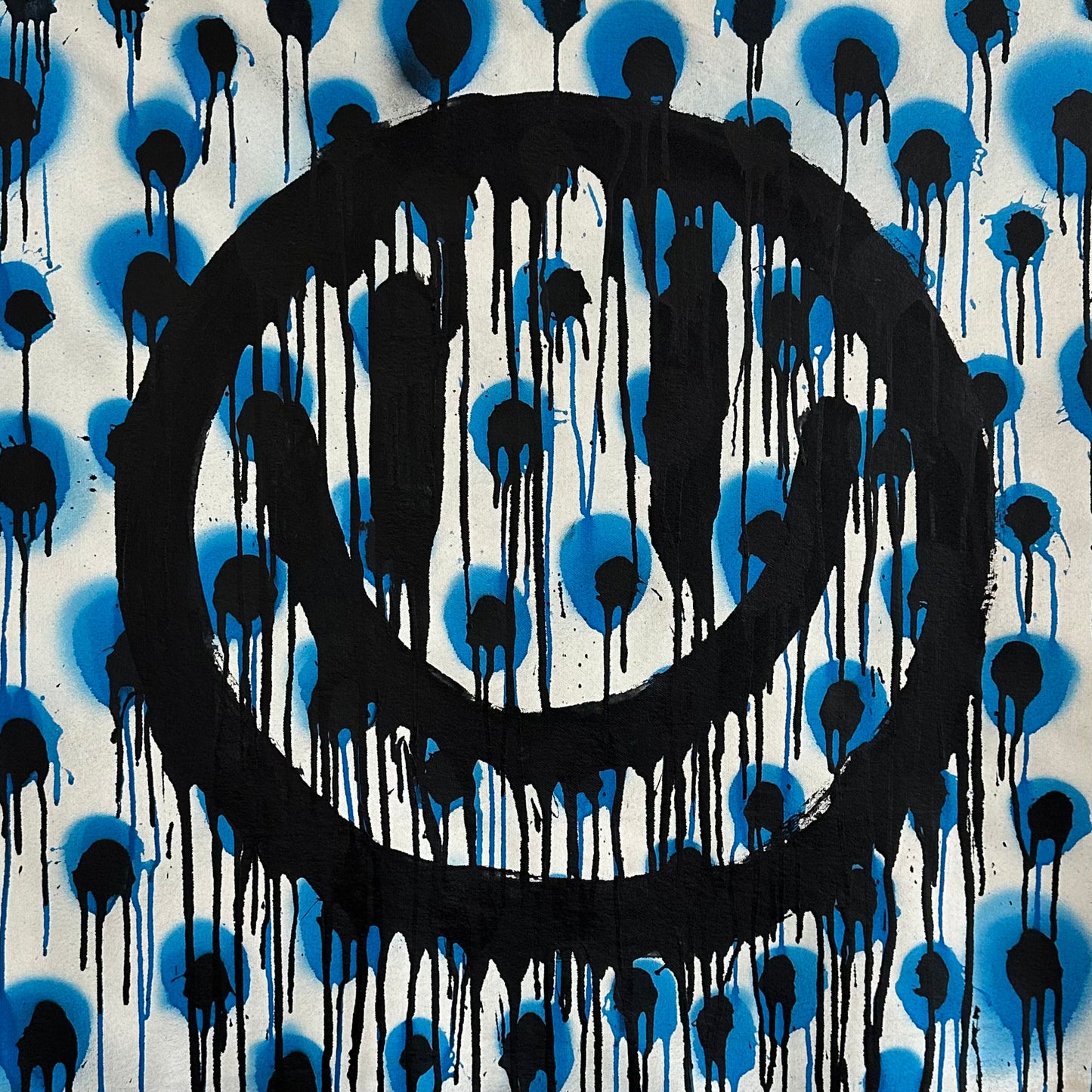 Drippy smiley on Black and blue polkadots