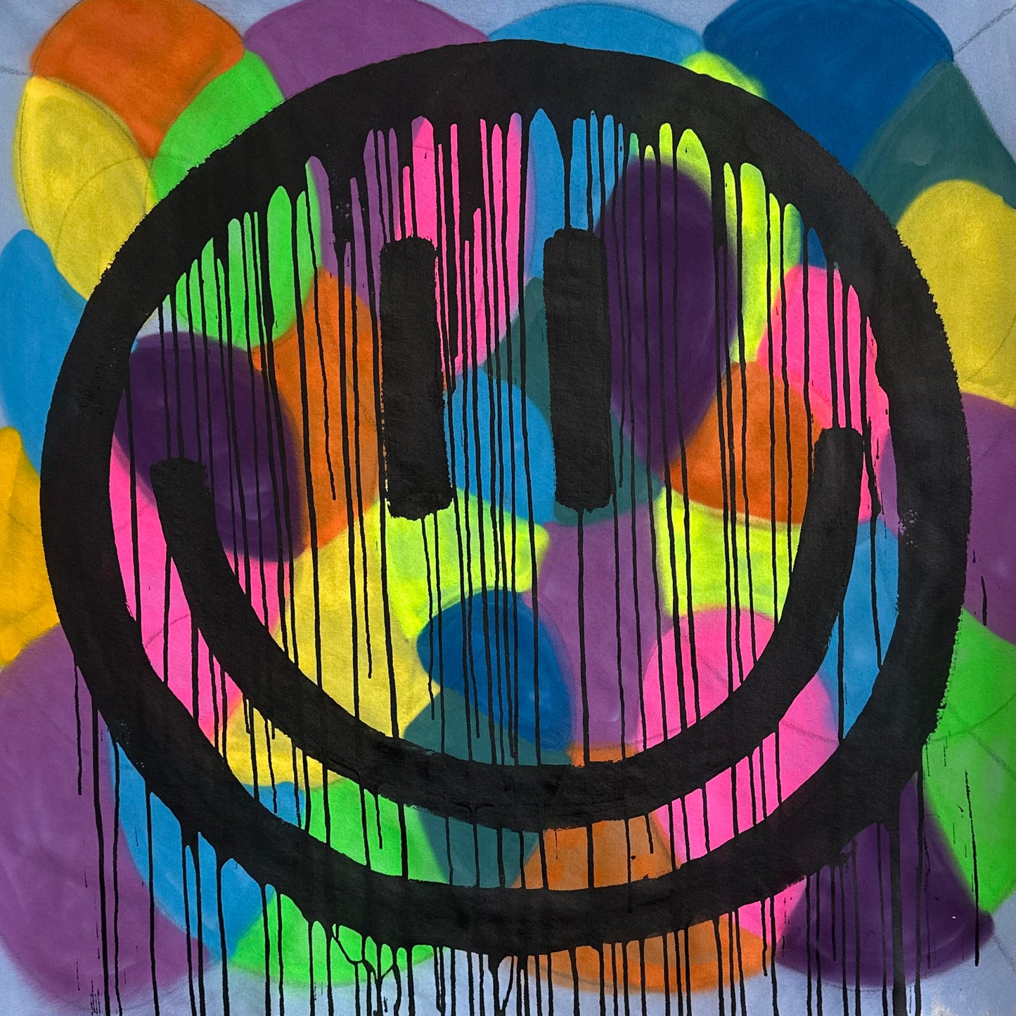 Colorful drippy smiley on blue